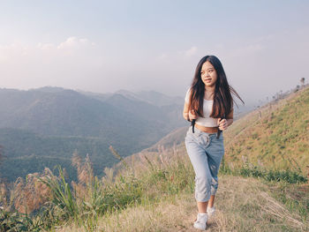 Wanderlust and travel concept from happy asian young woman walking trail in mountain