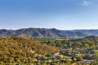 Scenic view of mountains against clear blue sky