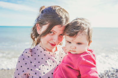 Portrait of mother and daughter at beach