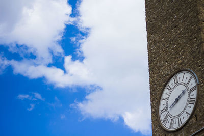 Low angle view of clock tower against blue sky