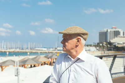 Portrait of man wearing hat against sea against sky