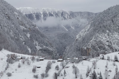 Scenic view of snow covered mountains against sky