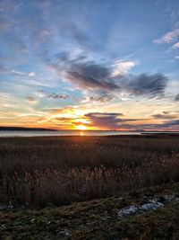 Scenic view of sunset over land