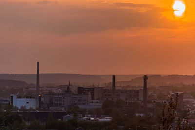 High angle view of illuminated city against orange sky