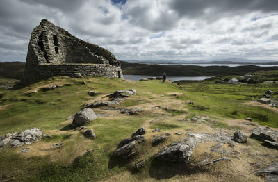 Scenic view of rocks on landscape against sky