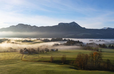 Austria, upper austria, mondsee, drone view of foggy sunrise over salzkammergut mountains in autumn