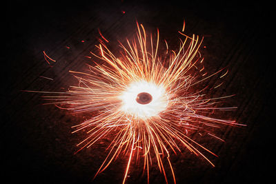 Low angle view of firework display at night