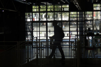 Woman standing by railing
