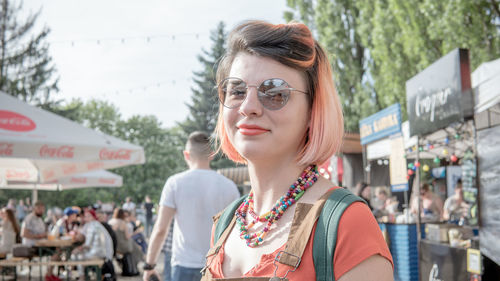 Portrait of young woman looking away outdoors