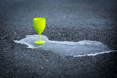 Close-up of yellow drink on road