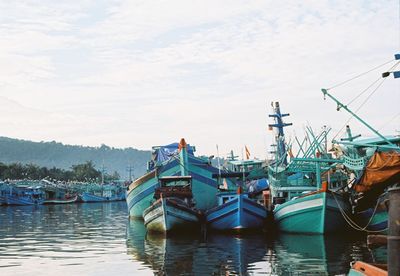 Boats moored at harbor