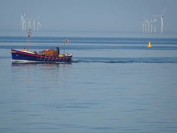 Sailboat in sea against sky