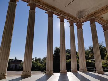 Low angle view of colonnade against clear sky