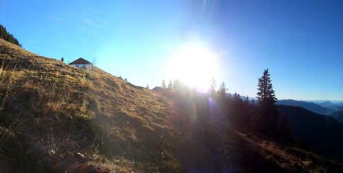 Panoramic view of sun shining over mountain