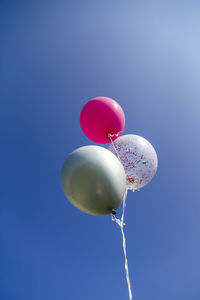 Birthday helium balloons in the blue sky, happy birthday