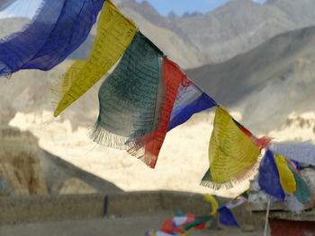 Multi colored flags hanging on mountain