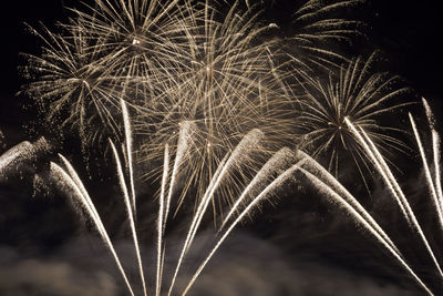 Low angle view of firework display at night