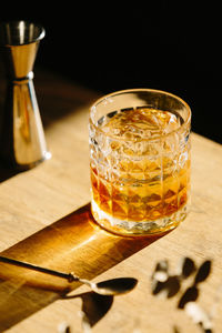 Close-up of glass with bourbon whiskey on table