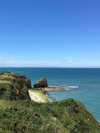 Scenic view of sea against blue sky