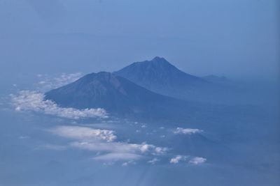 Scenic view of snowcapped mountains against cloudy sky