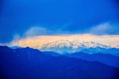 Scenic view of mountains against blue sky