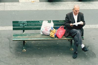 Full length of a man sitting on road