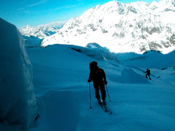 People skiing on snowcapped mountains