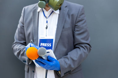 Midsection of man holding umbrella