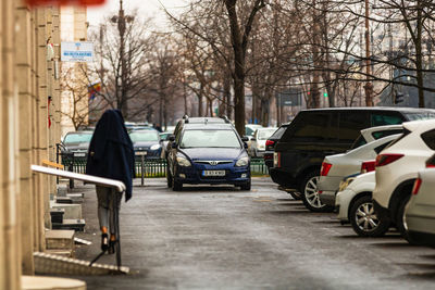 View of cars on street in city