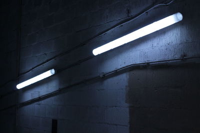 Low angle view of light bulbs on wall