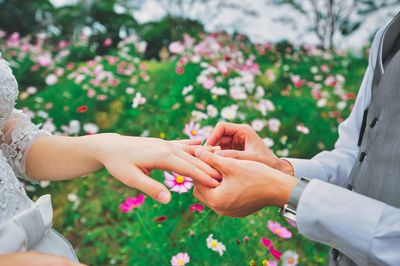 Midsection of couple holding hands