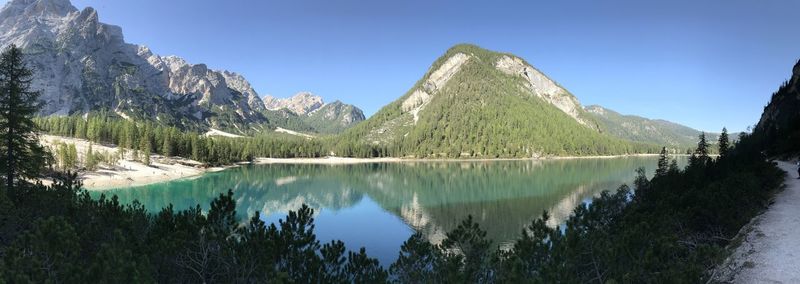 Scenic view of lake and mountains against blue sky