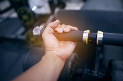 Close-up of person hand holding exercising in gym