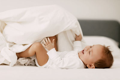 Cute boy lying on bed