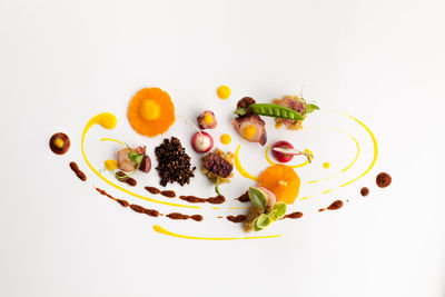 High angle view of dessert in plate against white background