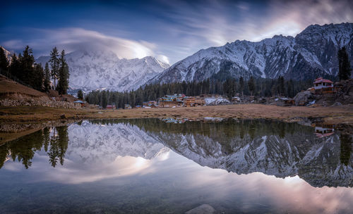 Scenic view of lake and mountains against sky