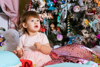 New year merry christmas, happy holidays. portrait of little girl in pink dress