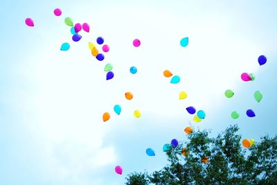 Low angle view of balloons against sky