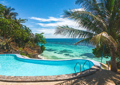 Scenic view of swimming pool by sea against sky
