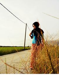 Girl holding grass in field