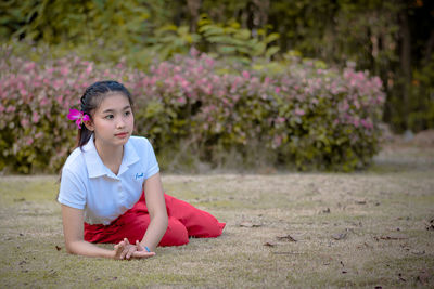 Portrait of a smiling girl sitting on land