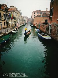 Canal amidst buildings in city