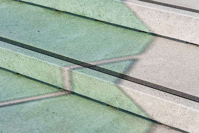 High angle view of shadow on footpath by swimming pool