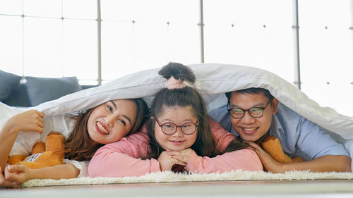 Portrait of mother and daughter on bed