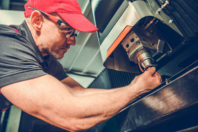 Side view of man working in workshop