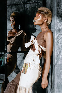 Side view of a young woman standing in store