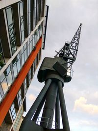 Low angle view of building against cloudy sky