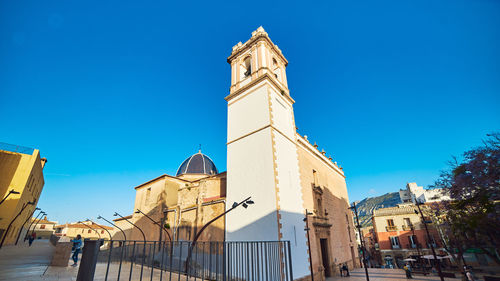 Low angle view of buildings against blue sky