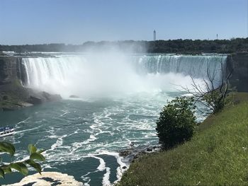 Scenic view of waterfall against sky