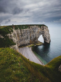 Rock formations by sea against sky